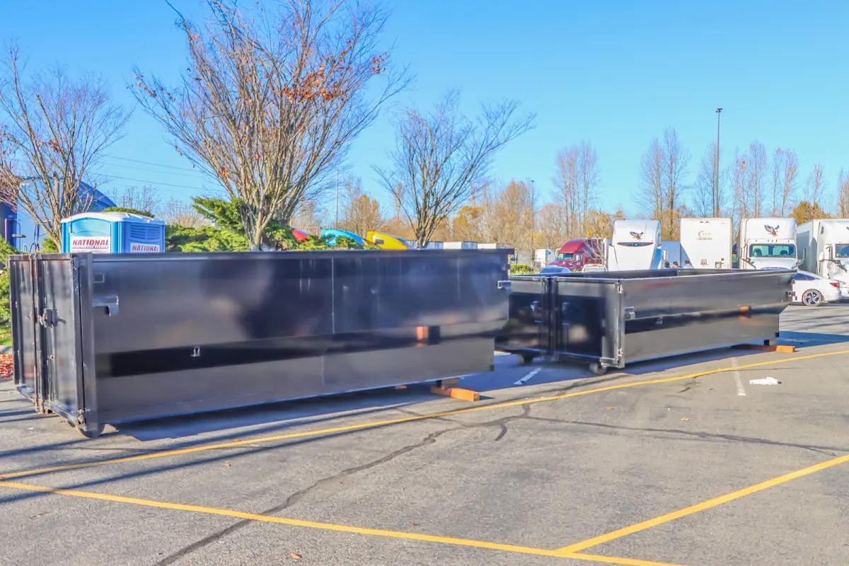 Professional dumpster rental service with roll-off container on residential driveway in South Plainfield